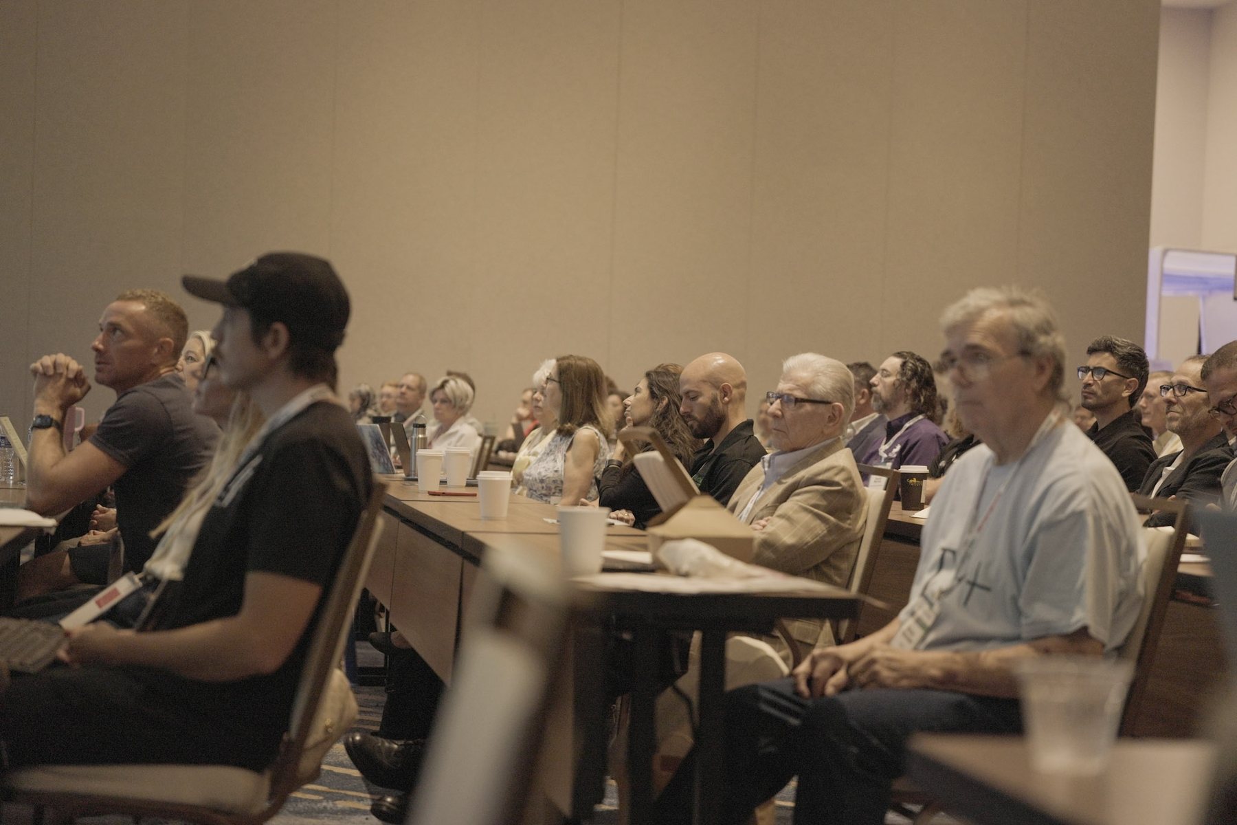 Conference attendees listening during a session