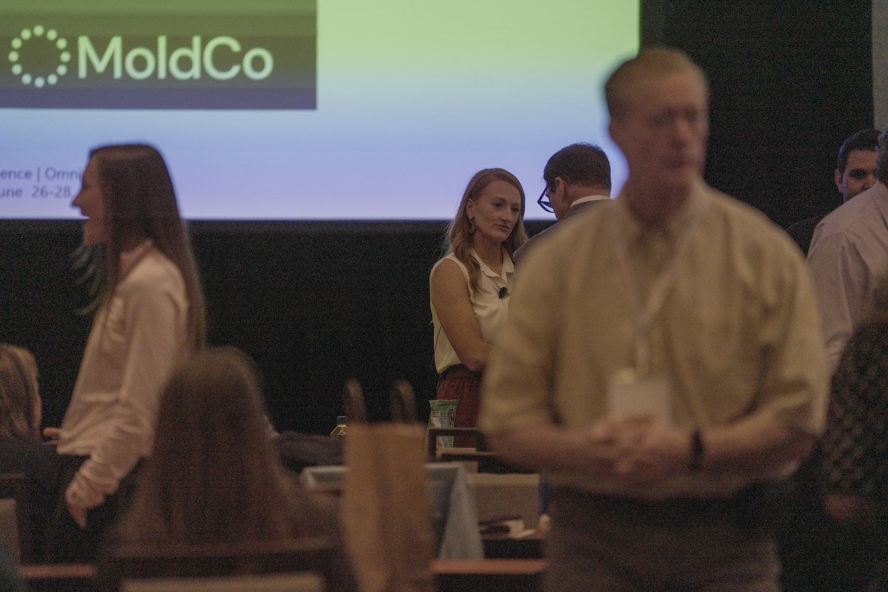 Attendees talking and networking during a conference break