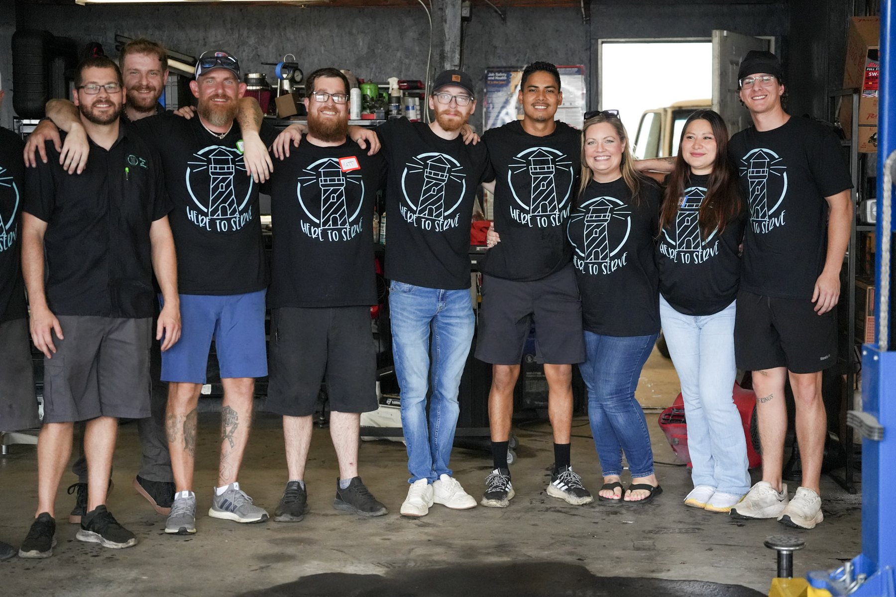 A local business team standing together in their shop