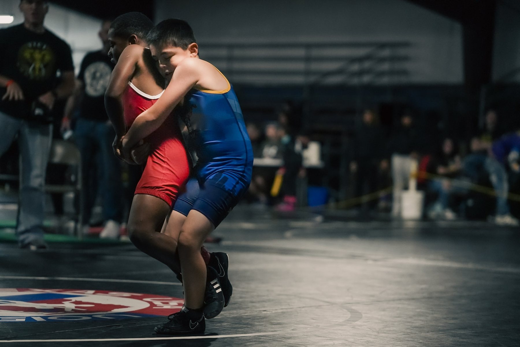 Two youth wrestlers locked up during a match