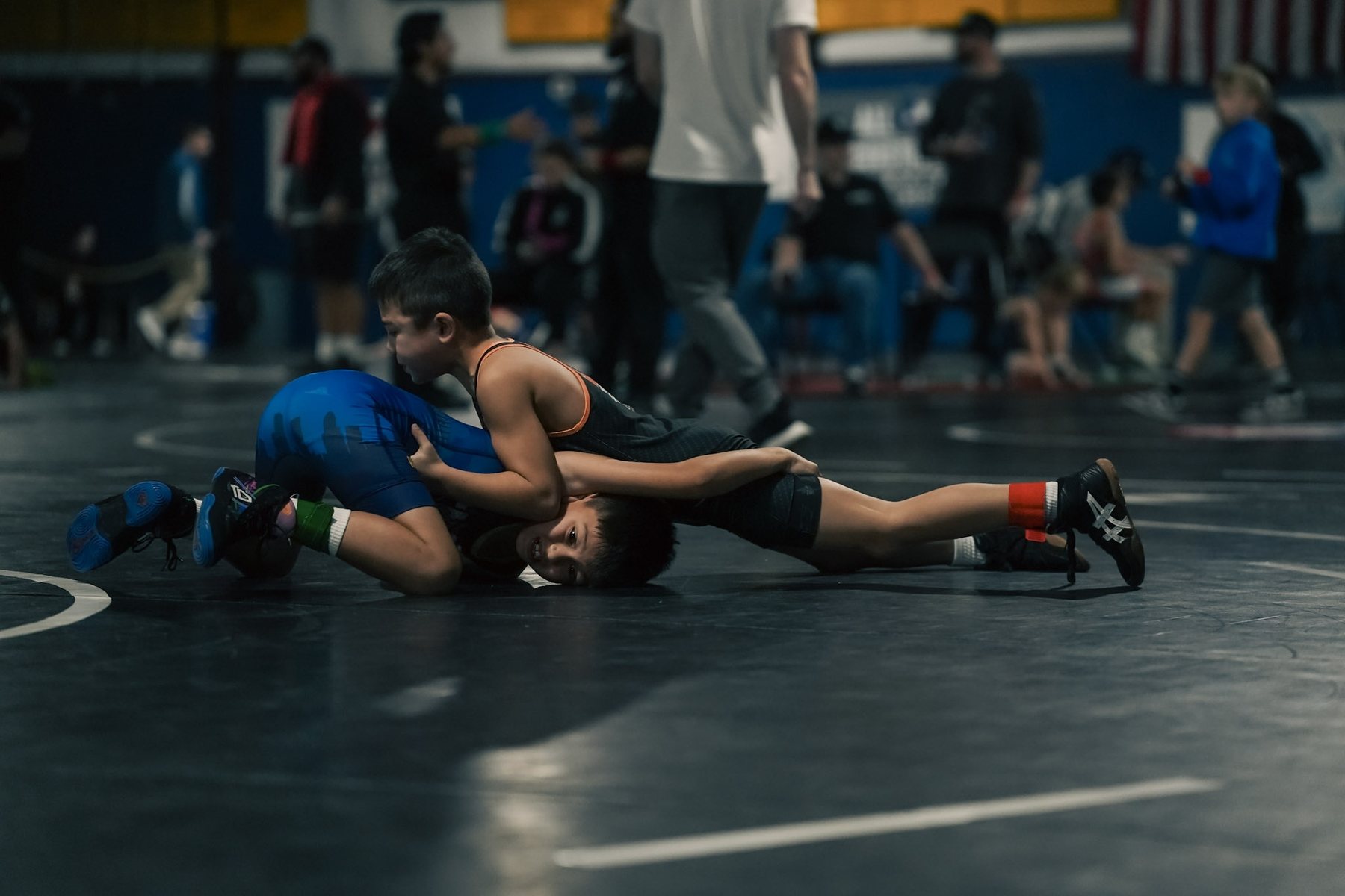 A youth wrestler working for a pin on the mat